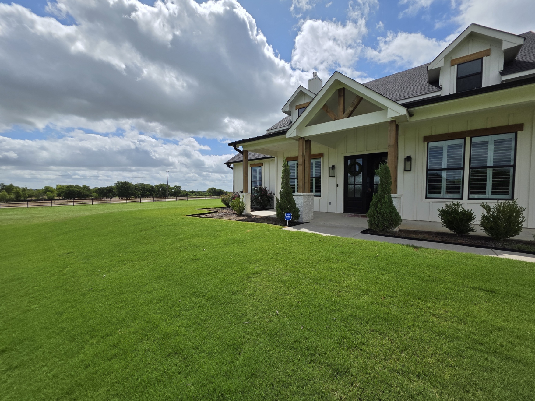 Freshly landscaped home with a lush green lawn